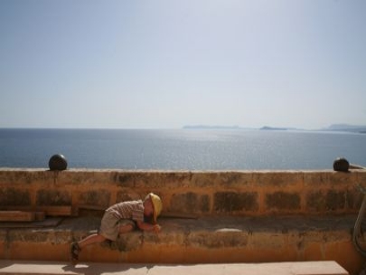 Sea behind him
